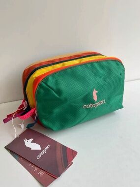 cotopaxi Green Toiletry Bag with Yellow & Orange Accents
